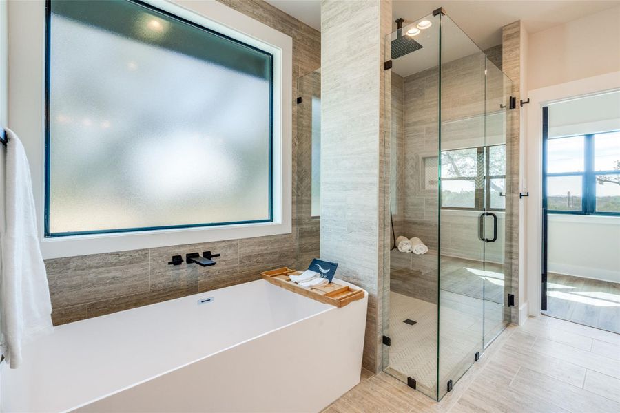 Full bath with a stall shower and a freestanding tub
