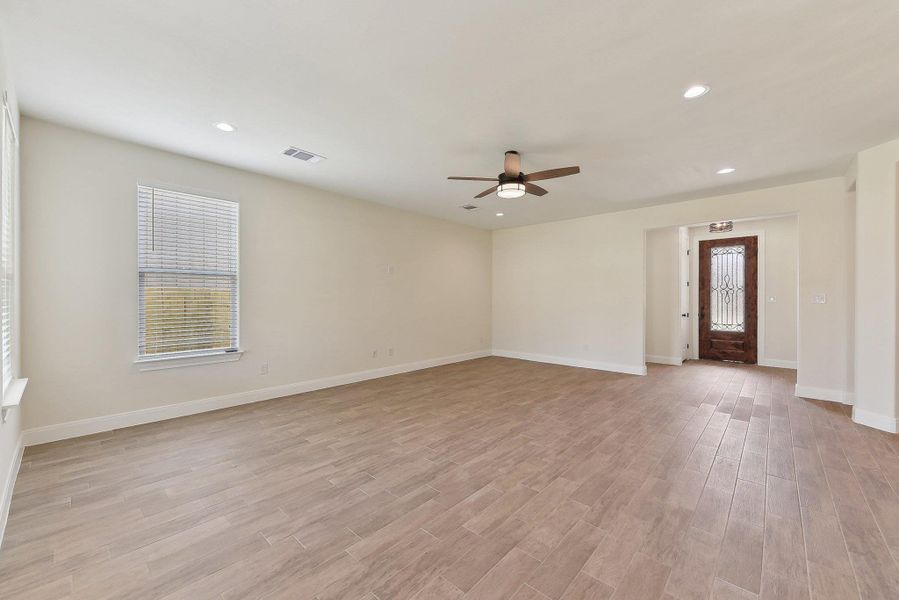 Empty room featuring recessed lighting, visible vents, baseboards, and light wood-style floors Empty room featuring recessed lighting, visible vents, baseboards, and light wood-style floors