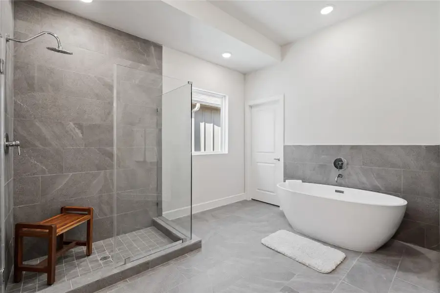 The primary bath pairs a freestanding soaking tub with a glass-enclosed shower, giving you both without having to choose. The primary bath pairs a freestanding soaking tub with a glass-enclosed shower, giving you both without having to choose.