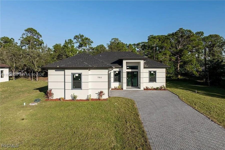 Front exterior of a new home in , Lehigh Acres, FL, highlighting curb appeal (Image 15).
