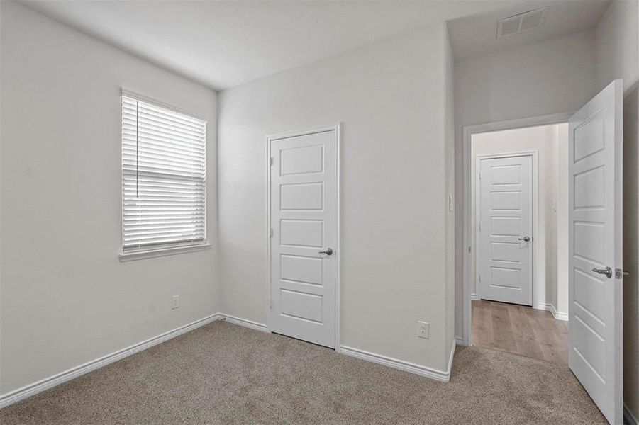 Bedroom featuring light colored carpet