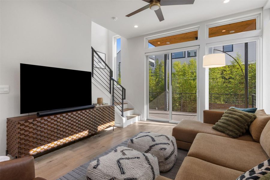 Living room featuring wood finished floors, ceiling fan, and recessed lighting