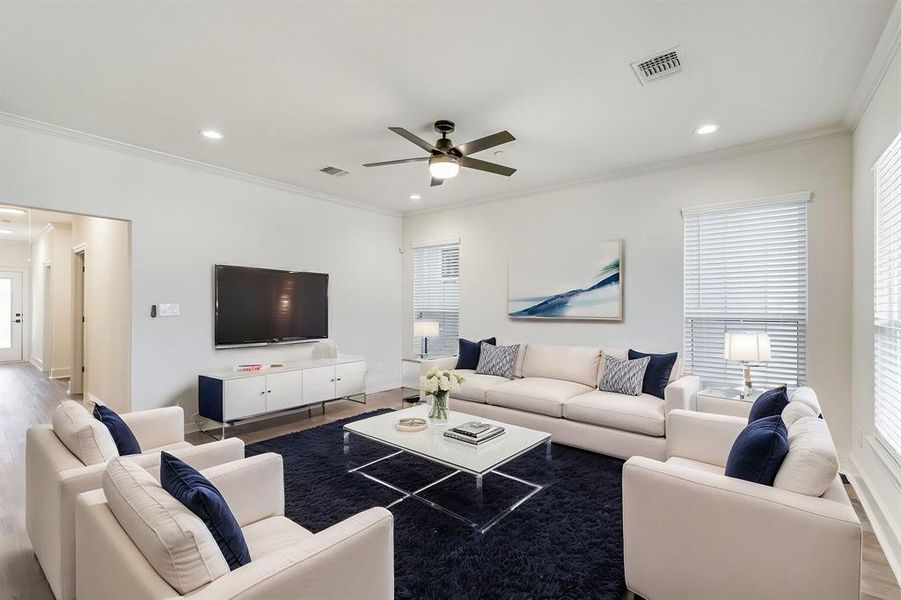 Living room with recessed lighting, crown molding, ceiling fan, and visible vents Living room with recessed lighting, crown molding, ceiling fan, and visible vents