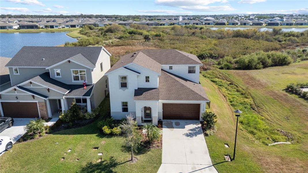 Front exterior of a new home in Isles at Bayview, Parrish, FL, highlighting curb appeal (Image 1).