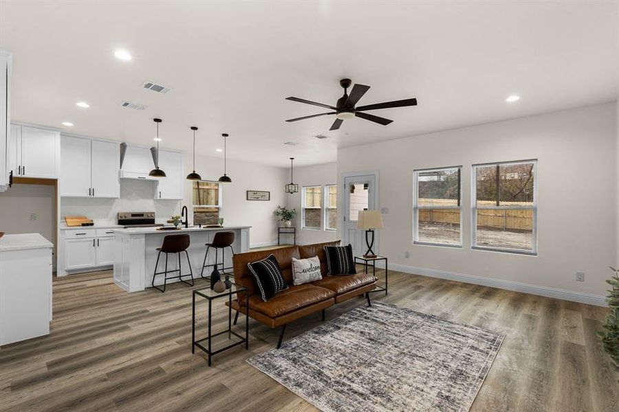 Living room featuring sink, hardwood / wood-style floors, and ceiling fan