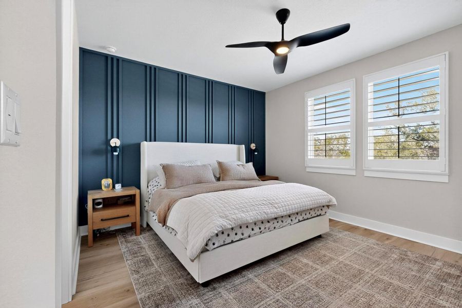 Primary Bedroom with light wood-style flooring and ceiling fan