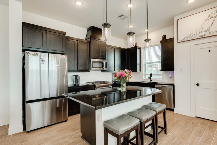 Kitchen features stainless steel appliances, granite countertops, and recessed lighting.