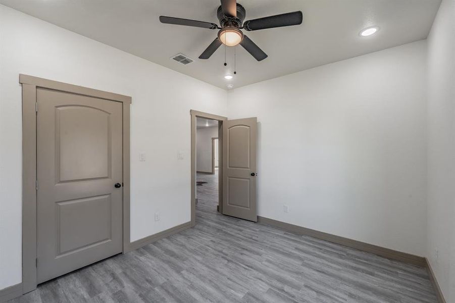 Unfurnished bedroom featuring light wood-style floors, recessed lighting, and ceiling fan