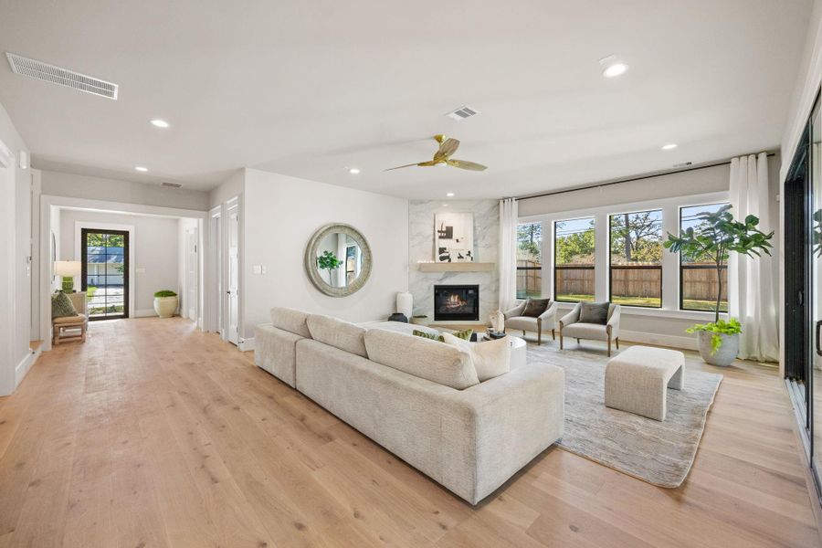 1st Floor layout is ideal for entertaining w/ wide open Family Room, Dining, Breakfast & Kitchen areas providing plenty of space for guests. A large wall of sliding glass doors leads to the covered Patio. Fireplace surround is a slab of Quartz w/ gas fireplace.