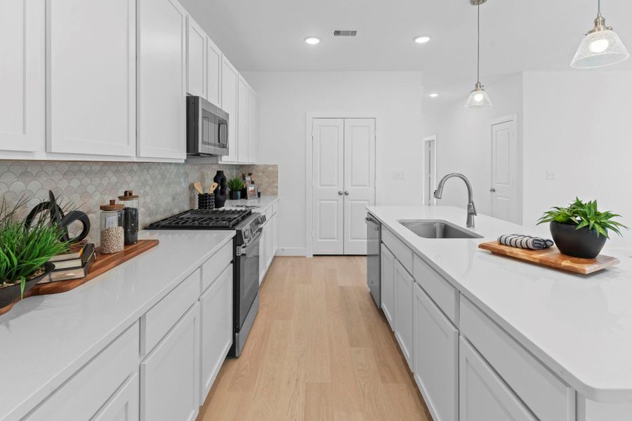 The heart of the home shines in this bright and stylish kitchen! You’ll love the large working station island with a deep undermount sink, pendant lighting, and plenty of counter space for cooking and entertaining.