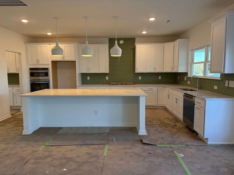 Kitchen featuring the AW Collection® Coastal - White cabinets and sea-glass tile backsplash.