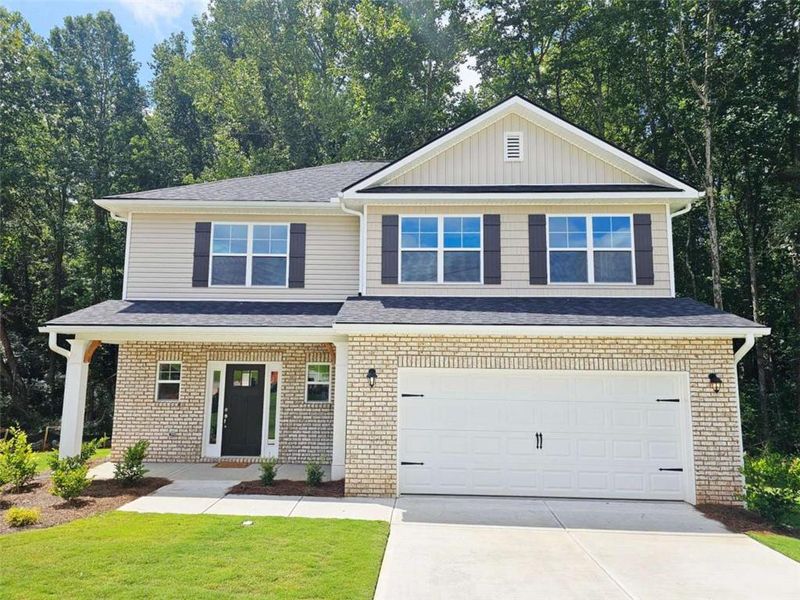 Front exterior of a new home in Scarlett Place, Bowdon, GA, highlighting curb appeal (Image 1).
