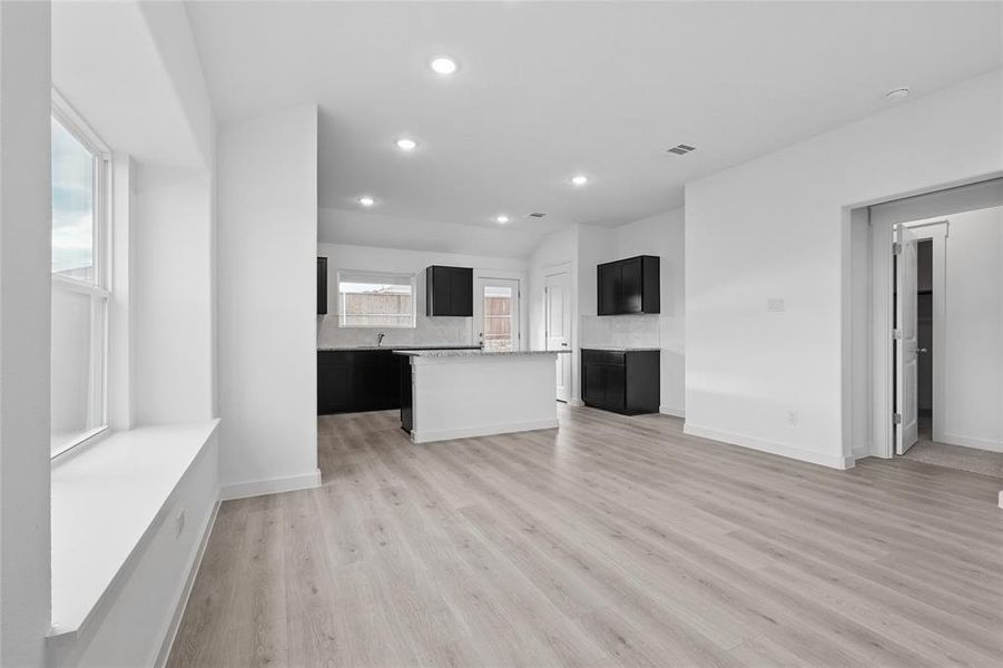 Unfurnished living room with light wood-type flooring and recessed lighting