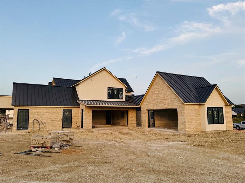 Huge motor court to serve these two oversized garages with covered breezeway.