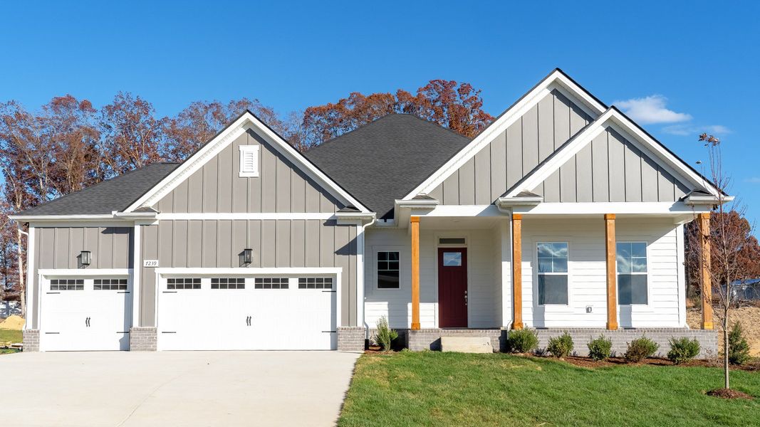 Exterior of home with white and gray siding and wood accent columns around covered front porch