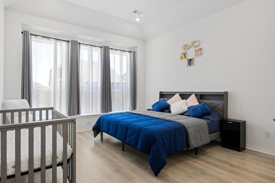 Bedroom with light wood-type flooring and recessed lighting Bedroom with light wood-type flooring and recessed lighting