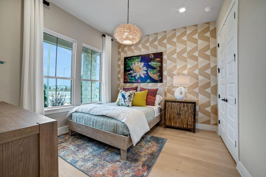 Bedroom featuring an accent wall, light wood-style flooring, and recessed lighting