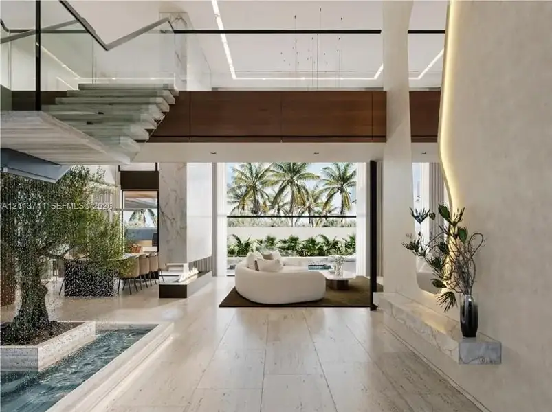 Open-concept interior featuring light stone flooring, a floating staircase with glass railings, a built-in stone water feature, a linear fireplace, and integrated accent lighting