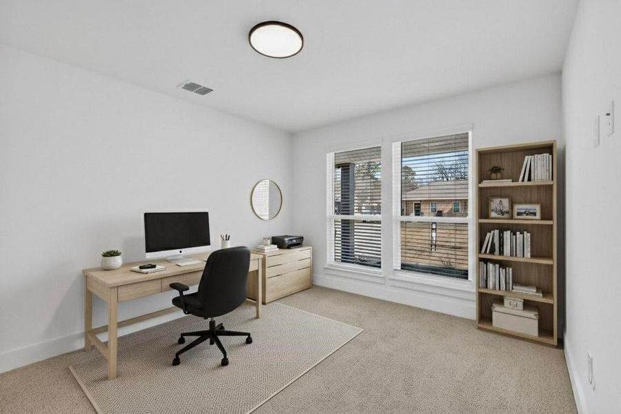 Office space with light colored carpet and baseboards