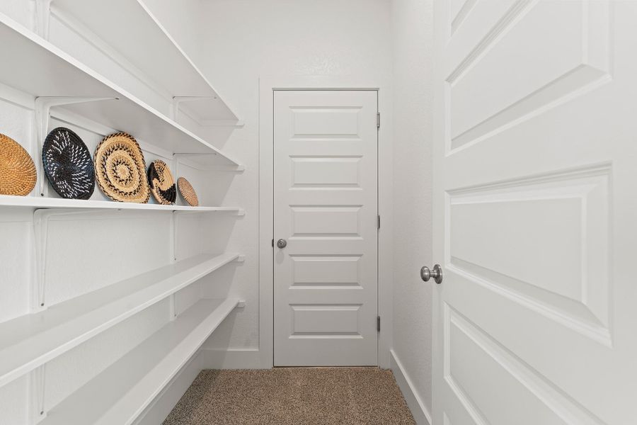 Spacious closet with light carpet Spacious closet with light carpet