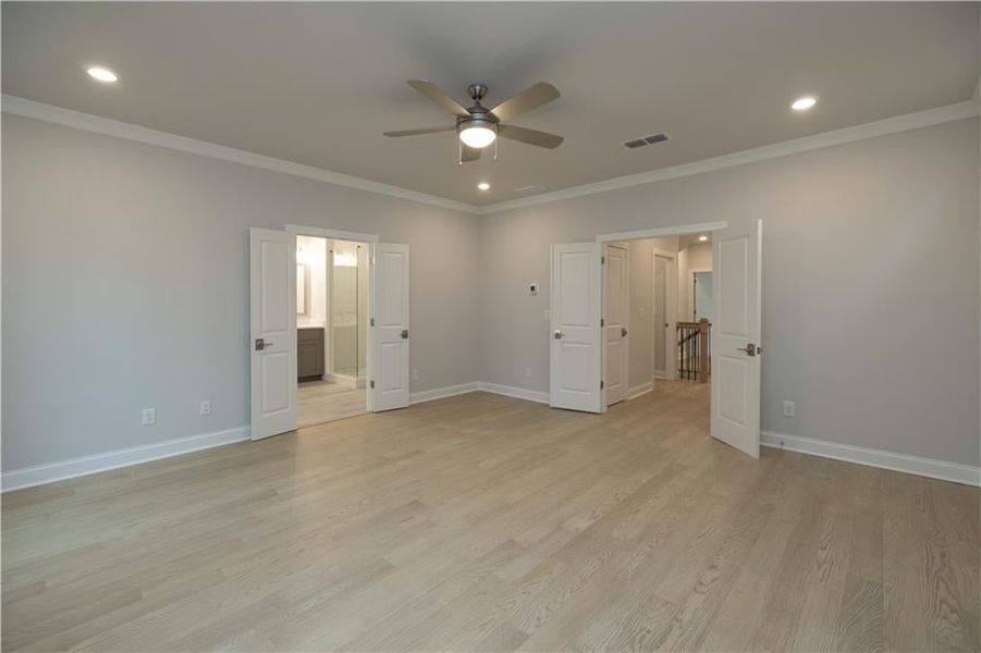 Gorgeous primary bedroom with double door entry! *Please note photos shown are of the Ellington plan but not of the actual home.