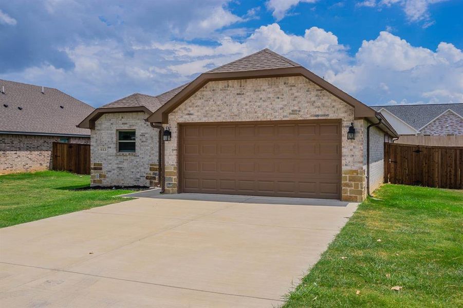 Beautiful brick ranch - wrought iron lanterns light the garage, painted gutters , stained privacy fence - this home is ready for you!