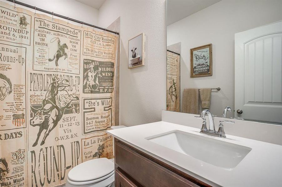 Bathroom with vanity and a shower with curtain Bathroom with vanity and a shower with curtain