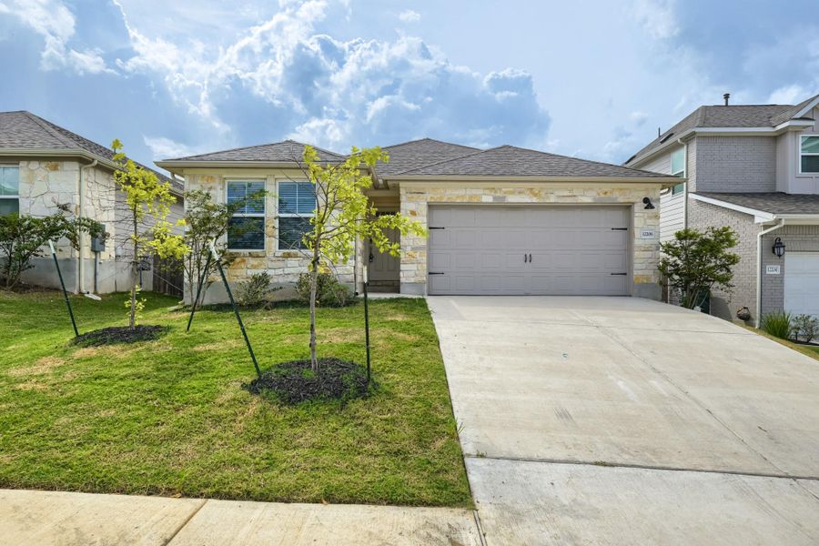 Front exterior of a new home in , Buda, TX, highlighting curb appeal (Image 2). Front exterior of a new home in , Buda, TX, highlighting curb appeal (Image 2).