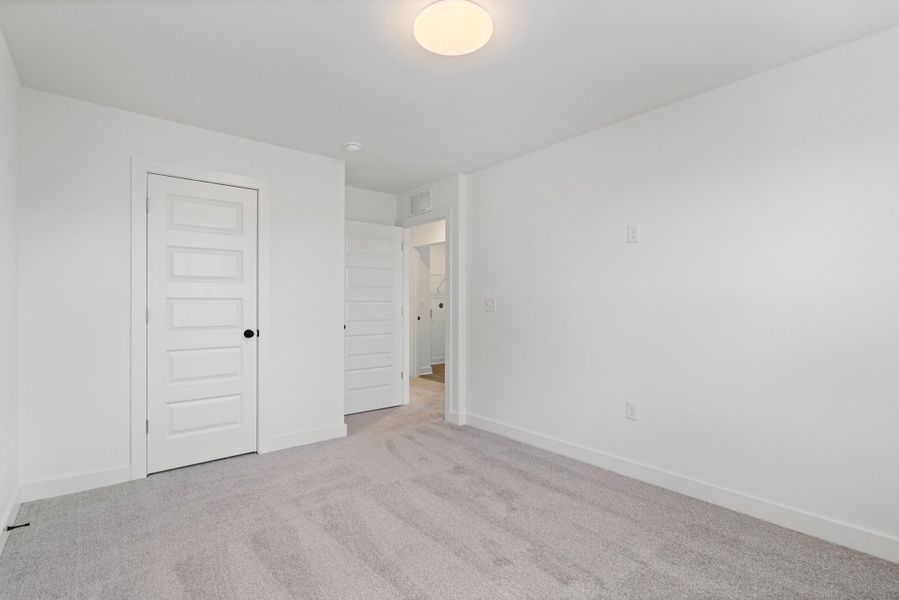 Recessed overhead lighting and light gray carpet Recessed overhead lighting and light gray carpet