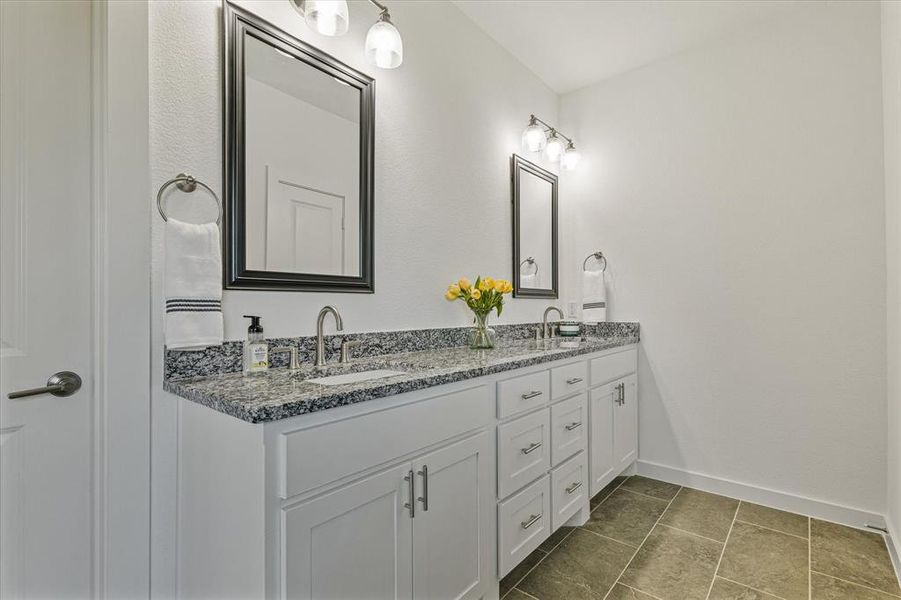 Bathroom featuring tile patterned floors and vanity Bathroom featuring tile patterned floors and vanity