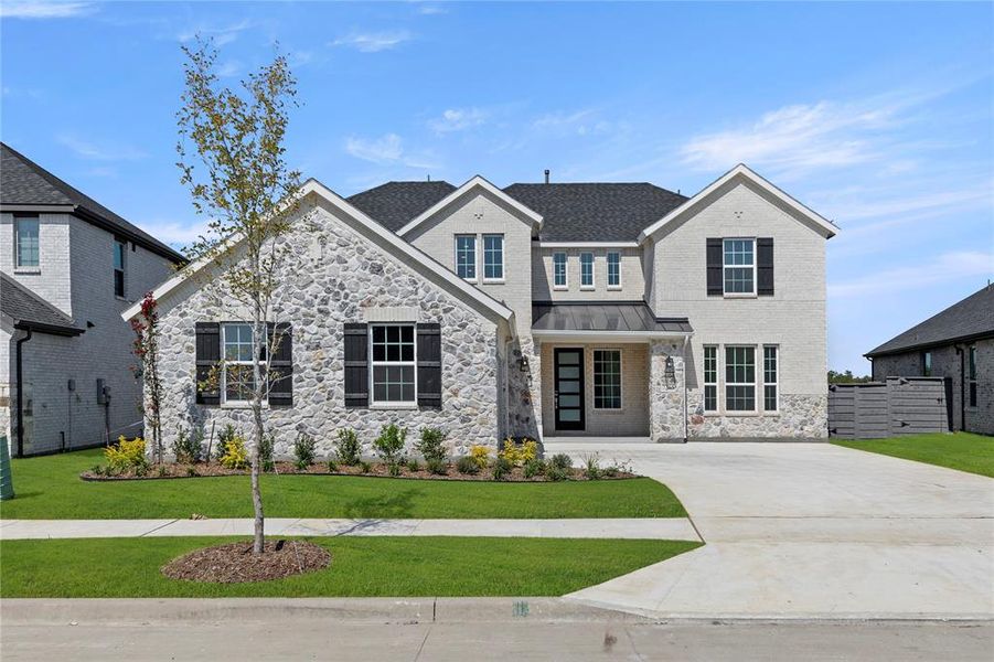Front exterior of a new home in Inspiration Collection at Union Park, Little Elm, TX, highlighting curb appeal (Image 1).