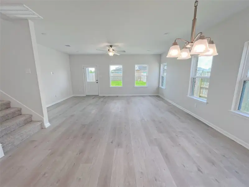 The Georgetown II- Dining into Family Room. Sample image for illustration; upgrades, options, and colors may vary.