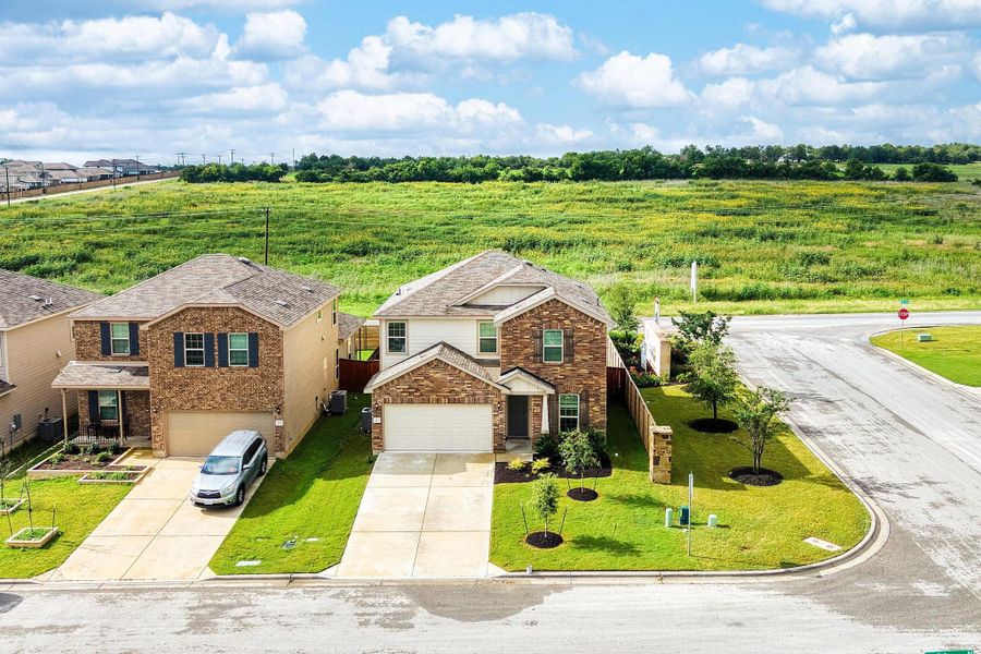 A classic brick exterior graces this appealing two-story home, nestled on a corner lot with a green landscape. A classic brick exterior graces this appealing two-story home, nestled on a corner lot with a green landscape.