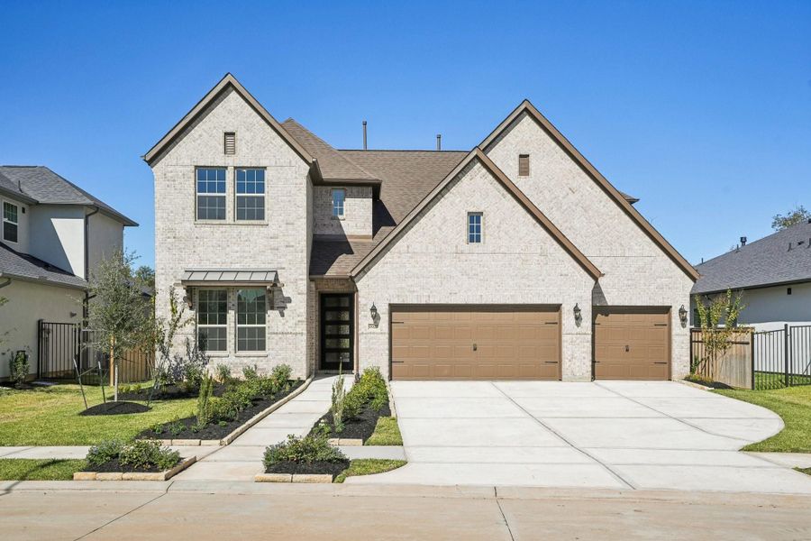 Front exterior of a new home in Sienna 65', Missouri City, TX, highlighting curb appeal (Image 25).