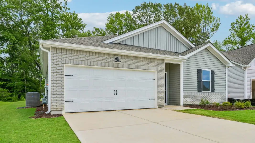 Front exterior of a new home in The Villas at Laurel Oaks, Sanford, NC, highlighting curb appeal (Image 17). Front exterior of a new home in The Villas at Laurel Oaks, Sanford, NC, highlighting curb appeal (Image 17).