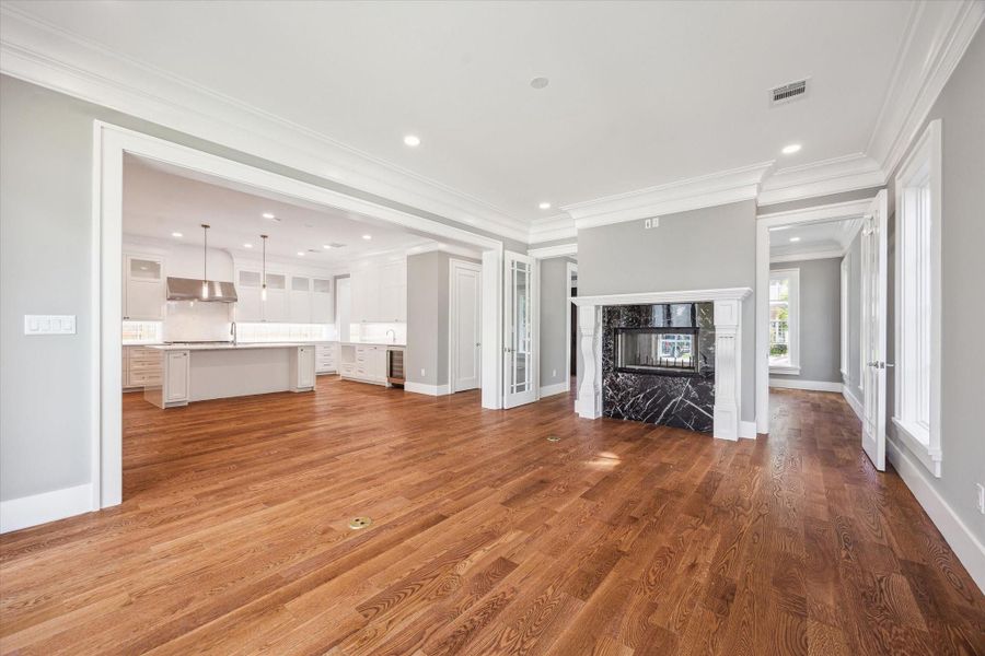 Another view of the open-concept family room and spectacular kitchen, complete with Subzero refrigerator/freezer and Wolf gas stove plus island with sink & dishwasher!   The fireplace adds warmth on cool days.