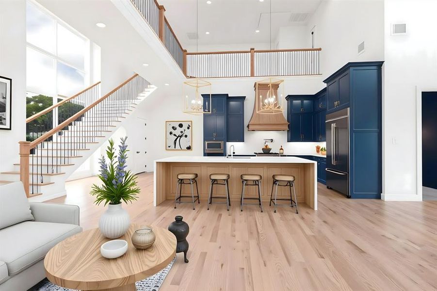 Kitchen with blue cabinets, custom exhaust hood, a towering ceiling, built in appliances, and a sink Kitchen with blue cabinets, custom exhaust hood, a towering ceiling, built in appliances, and a sink