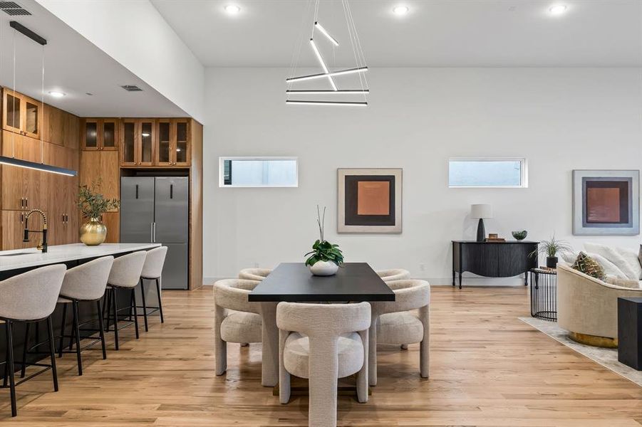 Dining space with a healthy amount of sunlight, light wood-type flooring, and sink