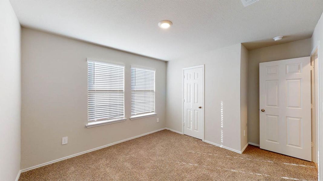 Unfurnished bedroom featuring light colored carpet and a closet