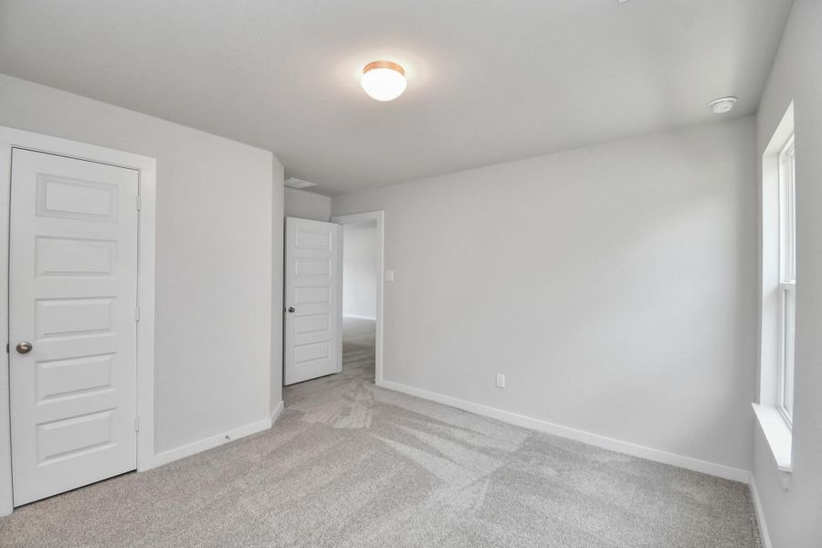 Secondary bedroom features plush carpeting, large windows that let in plenty of natural light, bright paint, and spacious closets. Secondary bedroom features plush carpeting, large windows that let in plenty of natural light, bright paint, and spacious closets.