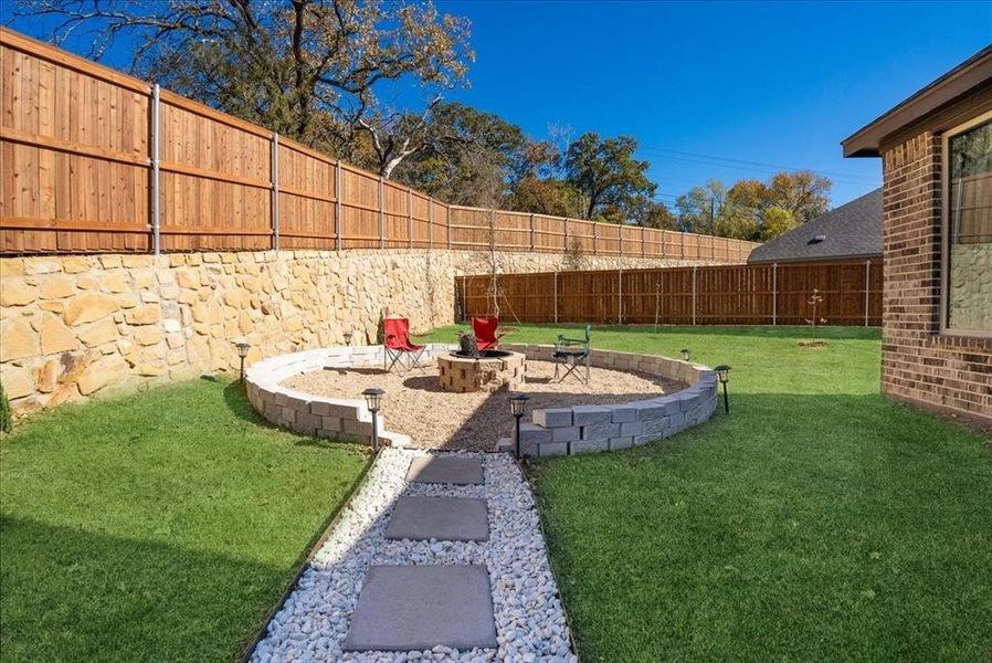 View of yard featuring an outdoor fire pit