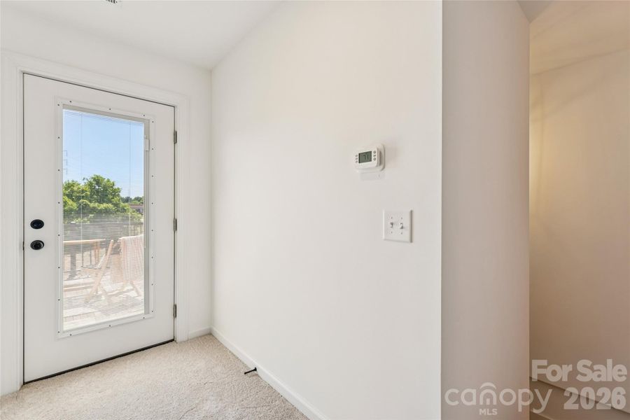 Top floor short hallway to back deck