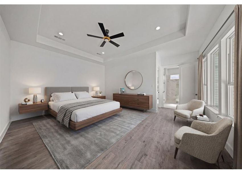 Virtually Staged - Bedroom with wood finished floors, a ceiling fan, a tray ceiling, recessed lighting, and ensuite bathroom