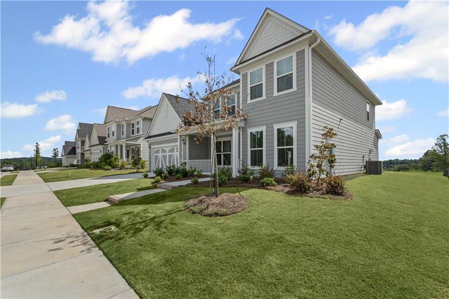 Front exterior of a new home in Reunion, Flowery Branch, GA, highlighting curb appeal (Image 20). Front exterior of a new home in Reunion, Flowery Branch, GA, highlighting curb appeal (Image 20).
