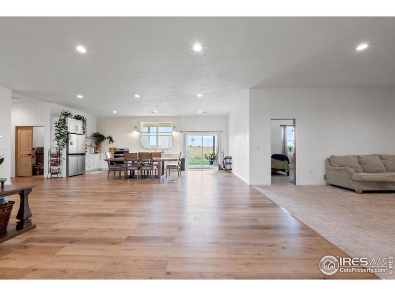 The layout flows seamlessly from the kitchen and dining area to the living space, creating an inviting atmosphere for gatherings and everyday living