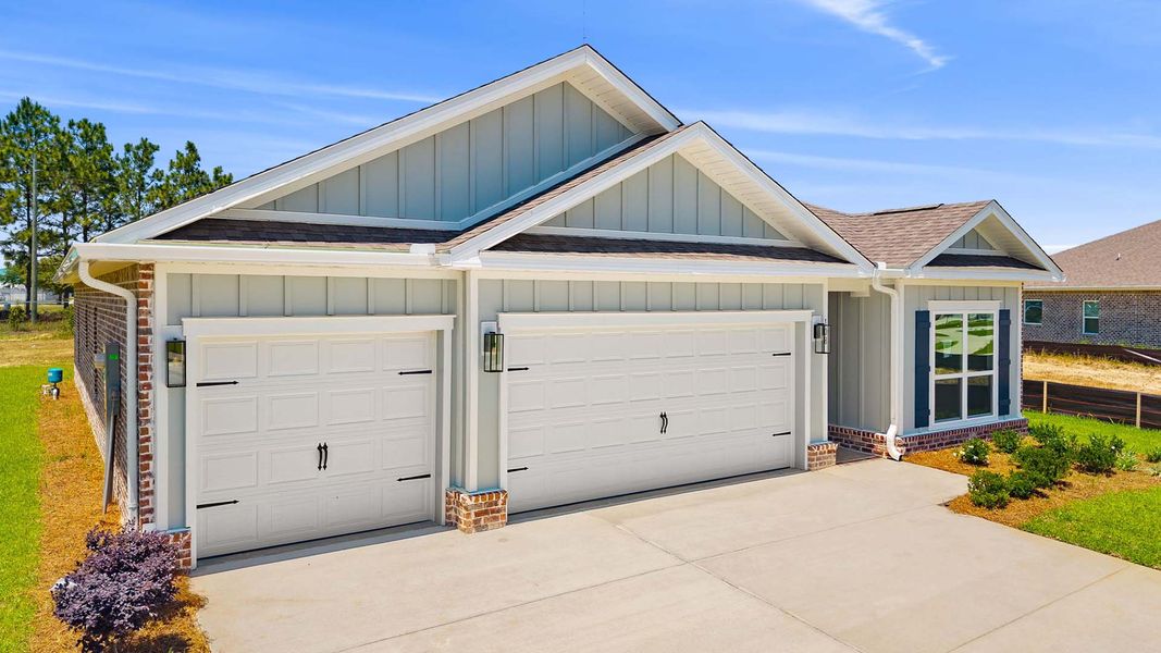 Front exterior of a new home in Owl's Head Farms, Freeport, FL, highlighting curb appeal (Image 2). Front exterior of a new home in Owl's Head Farms, Freeport, FL, highlighting curb appeal (Image 2).