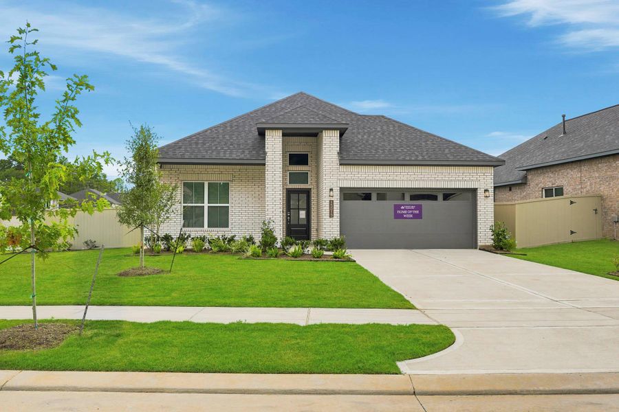 Front exterior of a new home in Audubon, Magnolia, TX, highlighting curb appeal (Image 1). Front exterior of a new home in Audubon, Magnolia, TX, highlighting curb appeal (Image 1).