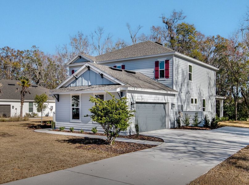 Front exterior of a new home in Osprey Cove, St. Marys, GA, highlighting curb appeal (Image 2). Front exterior of a new home in Osprey Cove, St. Marys, GA, highlighting curb appeal (Image 2).