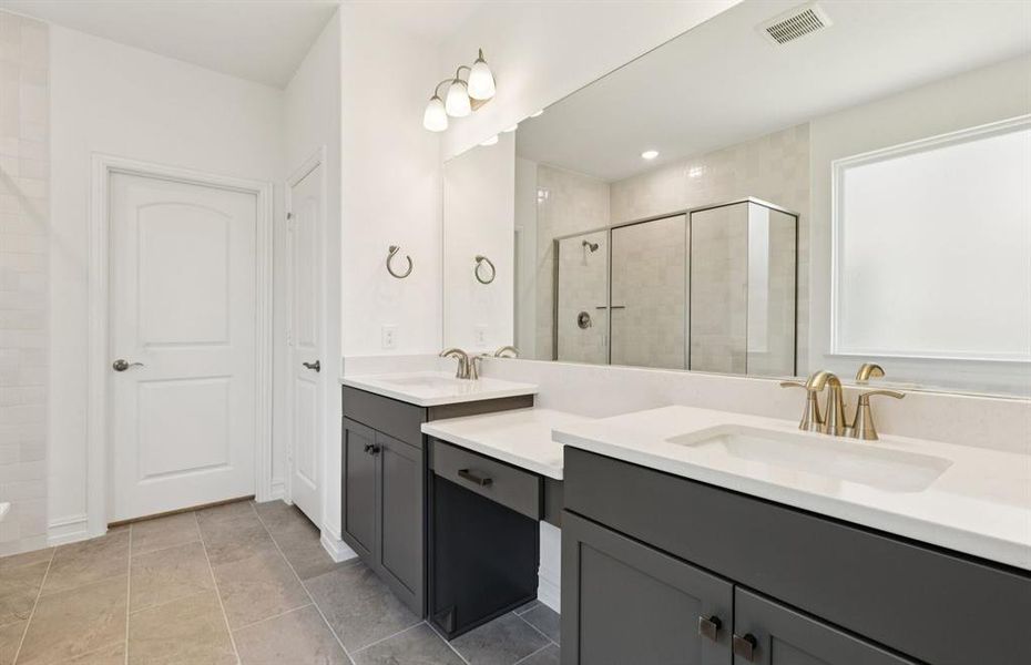 Elegant owner's bathroom with dual vanity *real home pictured