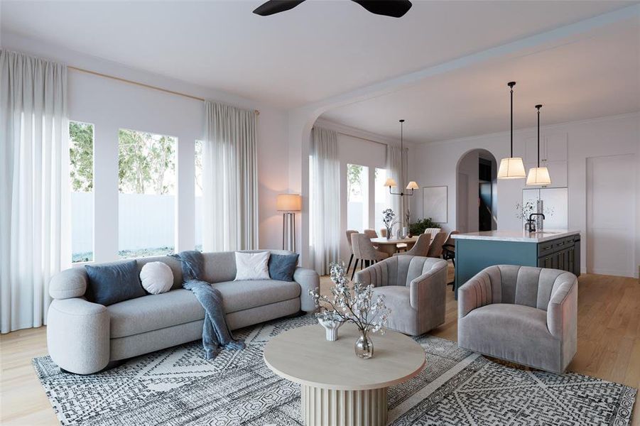 Living room featuring light wood finished floors, arched walkways, a chandelier, and ceiling fan